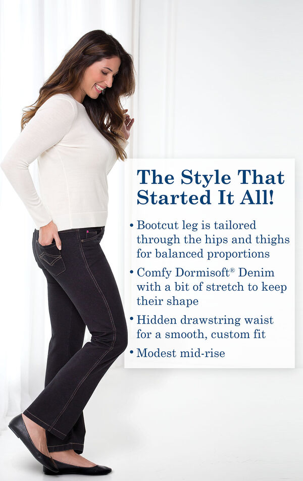 Model wearing Bootcut Black PajamaJeans with black flats and a white long-sleeve t-shirt and the following copy: Bootcut leg is tailored through the hips and thighs for balanced proportions. Comfy Dormisoft Denim with a bit of stretch to keep their shape. Hidden drawstring waist for a smooth custom fit. Modest mid-rise.