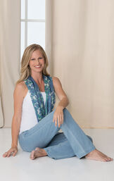 Model sitting wearing PajamaJeans - Bootcut Clearwater Wash paired with a white tank and scarf. image number 2