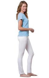 Model wearing Skinny White PajamaJeans barefoot, paired with a blue t-shirt image number 2