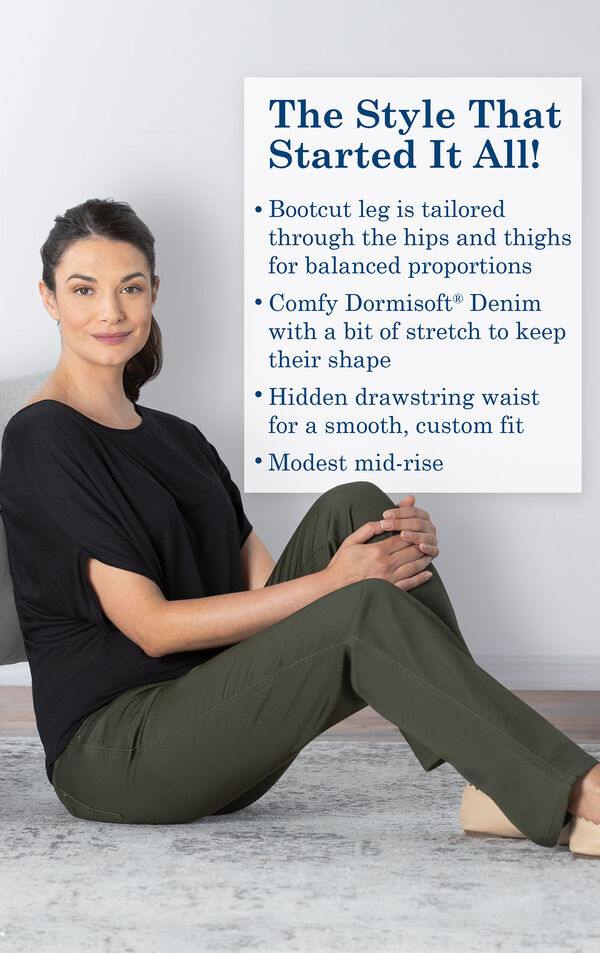 Model sitting down wearing Bootcut Olive PajamaJeans with the following copy: Bootcut leg is tailored through the hips and thighs. Dormisoft Denim with a bit of stretch to keep their shape. Hidden drawstring waist for a custom fit. Modest mid-rise.